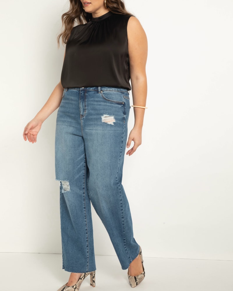 Front of a model wearing a size 14 Classic Fit Distressed Straight Leg Jean in Medium Wash by ELOQUII. | dia_product_style_image_id:206704